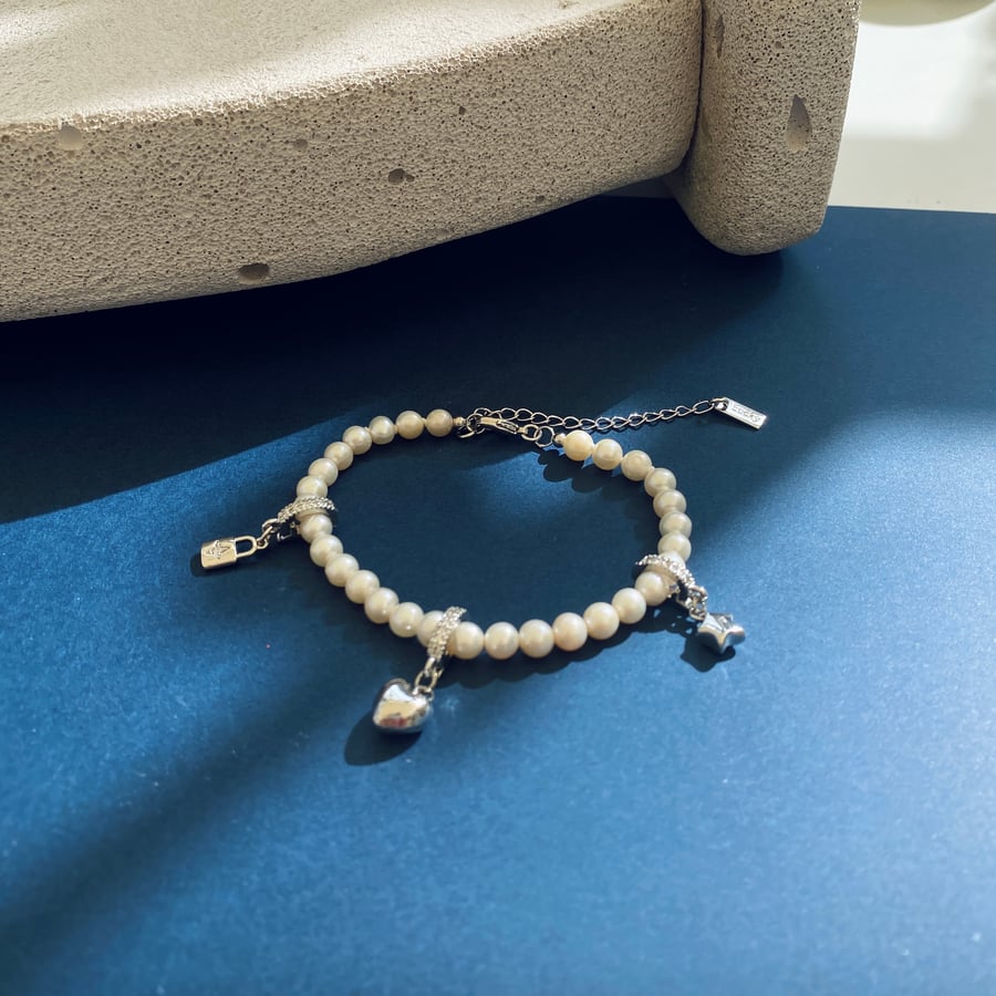 Lovely Freshwater Pearl with three charms bracelet in rodium plated