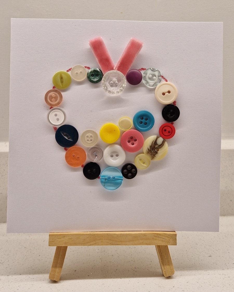 Any occasion card with a heart of multicoloured buttons with pink ribbon 