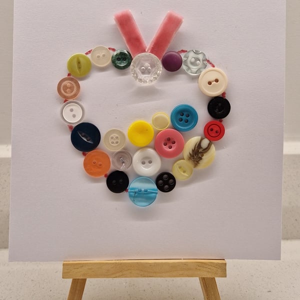 Any occasion card with a heart of multicoloured buttons with pink ribbon 