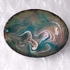 enamel brooch - scrolled pink, white, blue, brown on green over clear