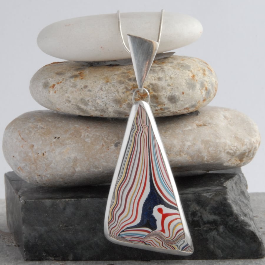 Large triangular fordite and sterling silver pendant