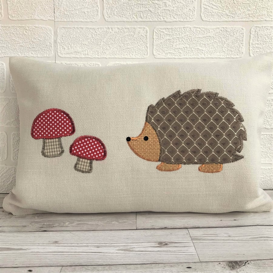 Hedgehog cushion in cream with brown lattice pattern hedgehog and red toadstools