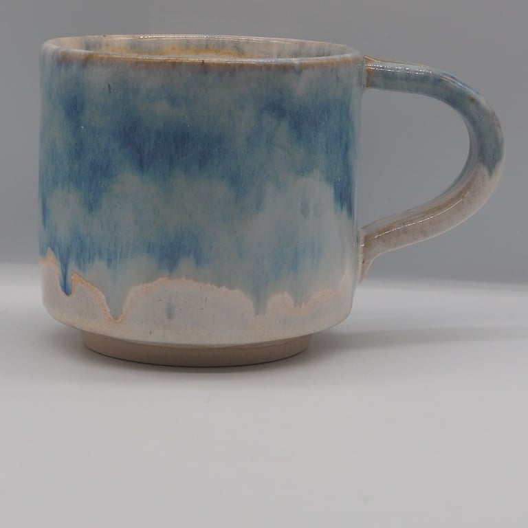 Large stoneware pottery mug finished in multi-coloured blue and white glaze.