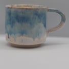 Large stoneware pottery mug finished in multi-coloured blue and white glaze.