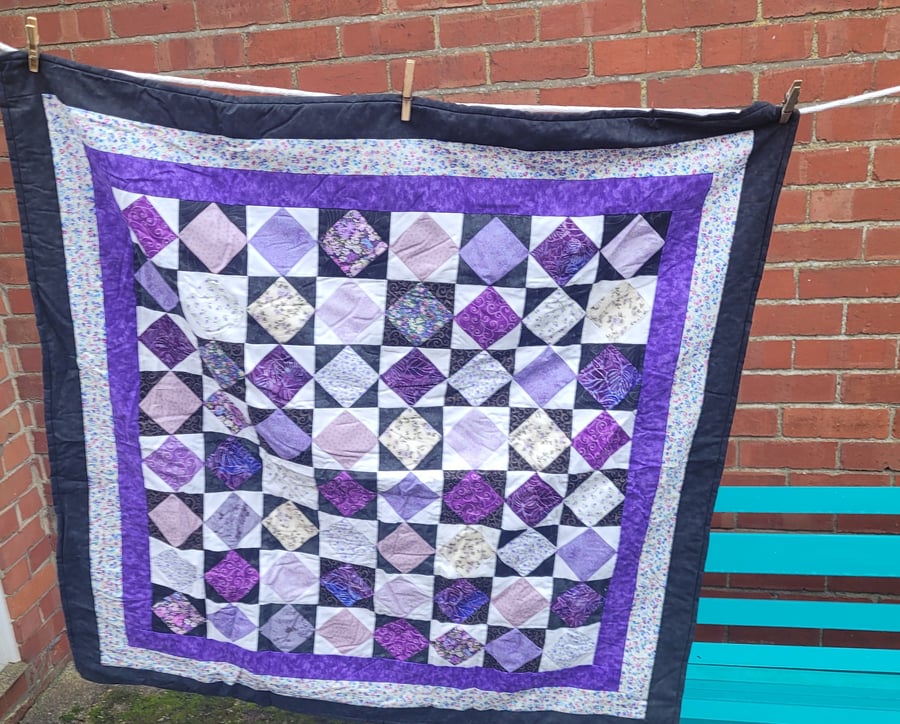 Square in a square black and purple patchwork quilt