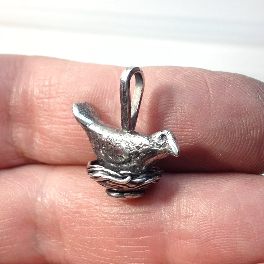 Silver bird on a nest pendant