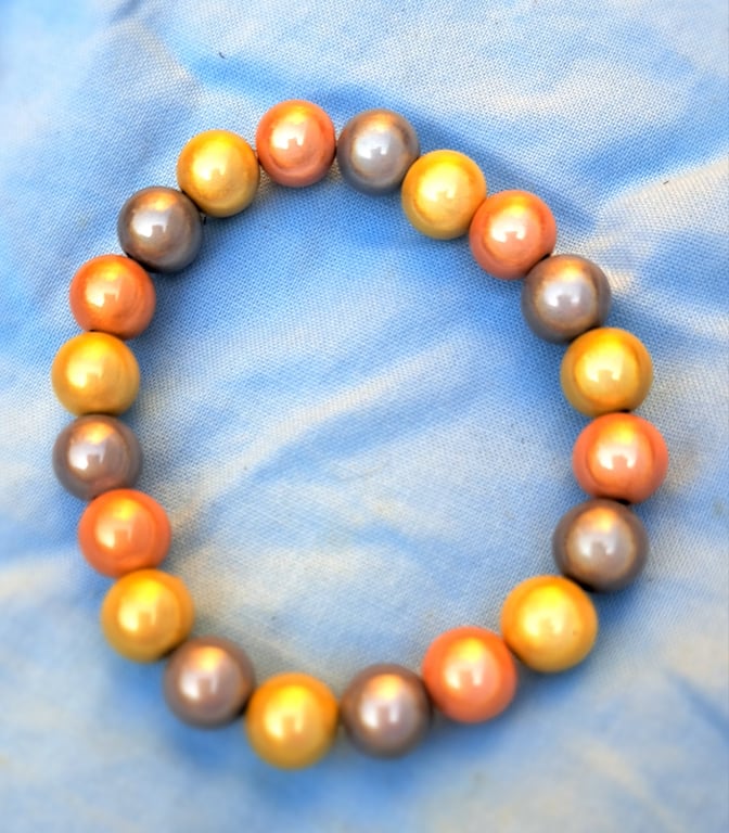 Disco bead bracelet, orange, yellow and silver elasticated