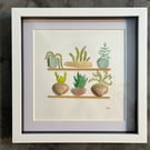 Sea glass, plants,and shells on shelves