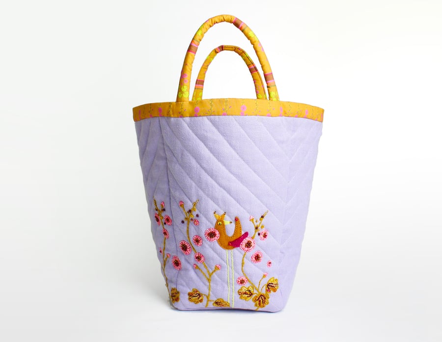 Big lilac linen project bag with hand embroidered bird and hollyhocks