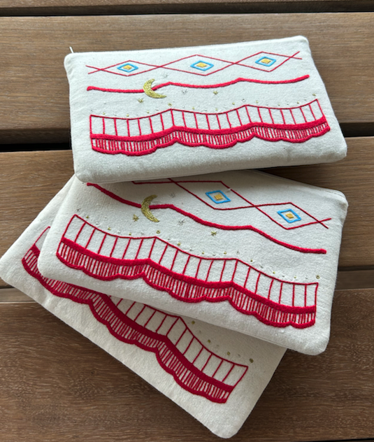 Hand embroidered purse created by Aprohade embroiderers in Rwanda