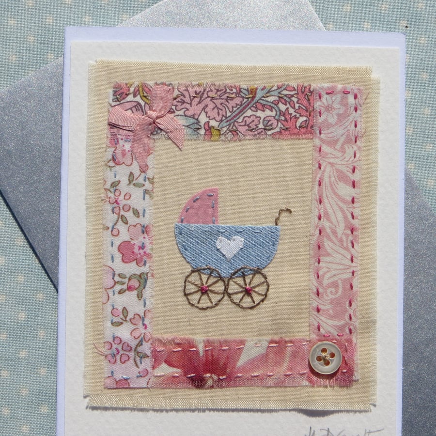 Little pram embroidered card to welcome a new baby, silk bow and mop button