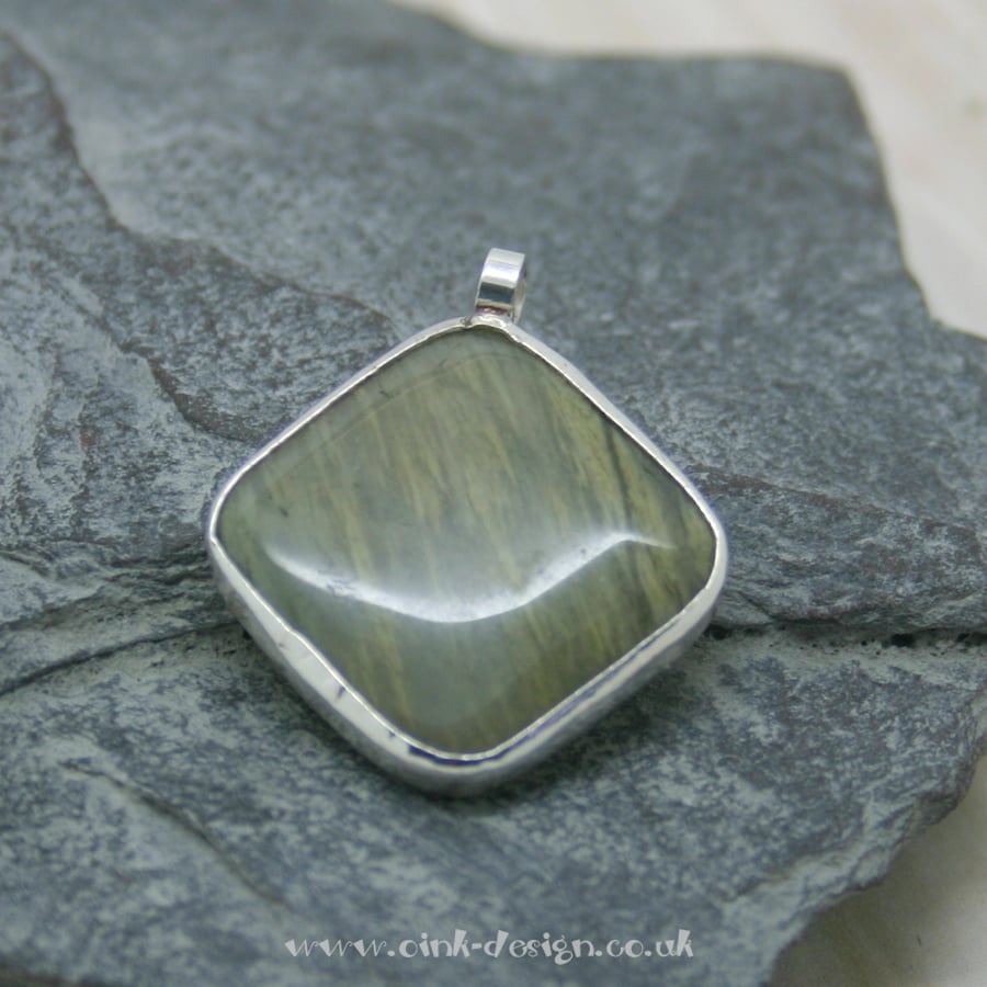 Nephrite gemstone pendant set in Sterling Silver spectacle setting
