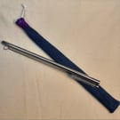 Reusable metal straw and cleaning brush with denim cover.