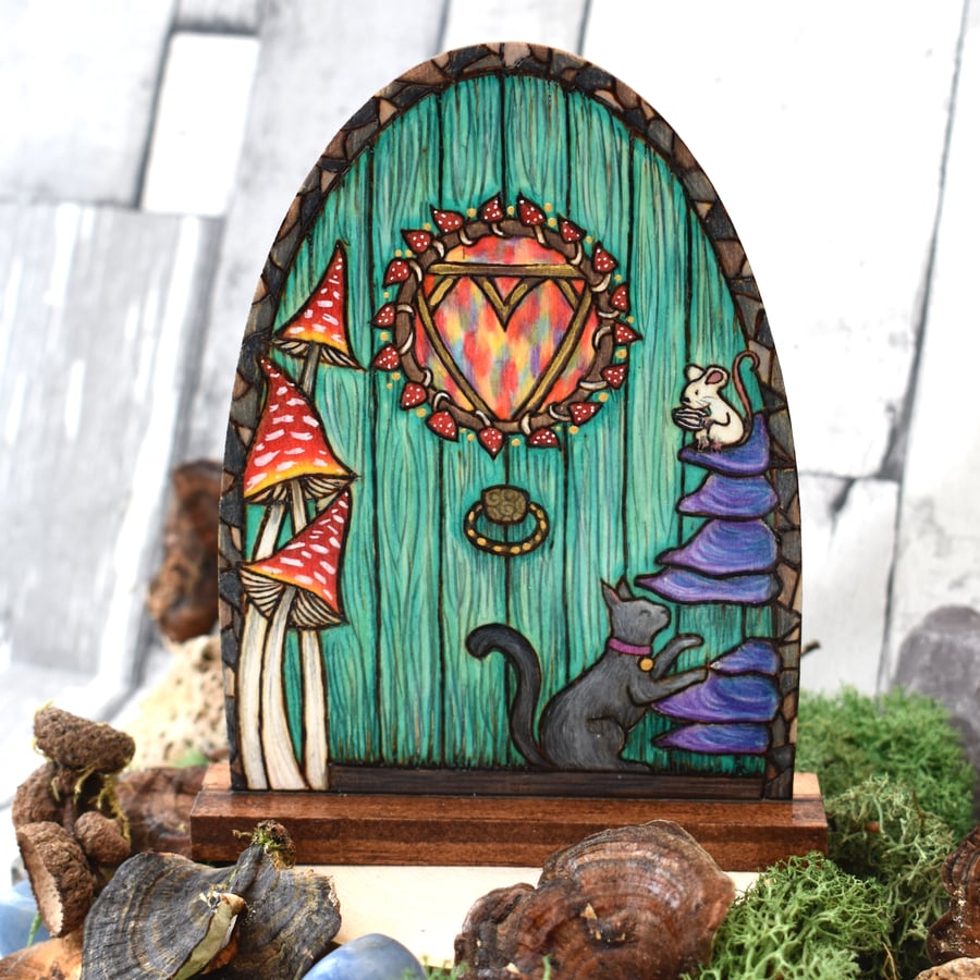 Green fairy door with cat and mouse. Pyrography decoration.