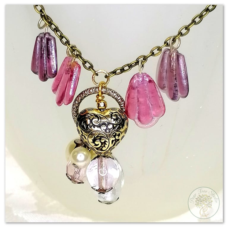 Handmade necklace with purple and white pearl glass beads with a gold heart