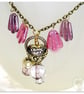 Handmade necklace with purple and white pearl glass beads with a gold heart