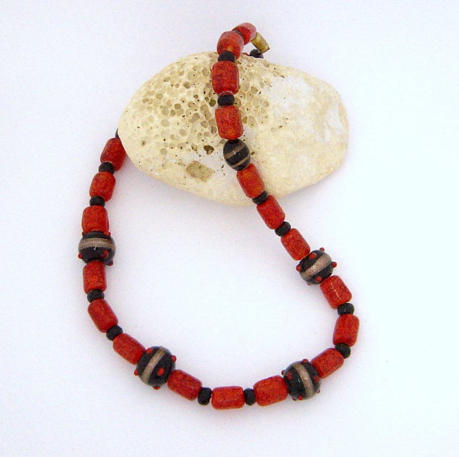 Glass bead necklace in red, black & gold