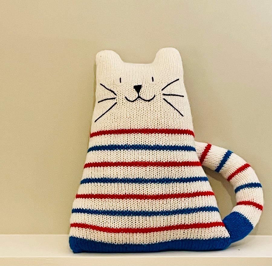 Knitted super soft white cat with red and blue thin stripes