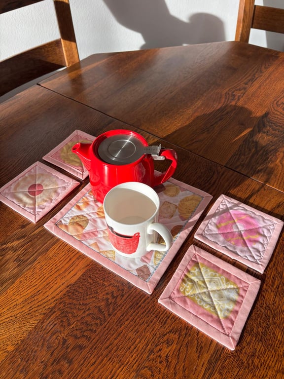 Set of Handmade Quilted Coasters – Biscuit Fabric, Mug Rugs, Pink Bind