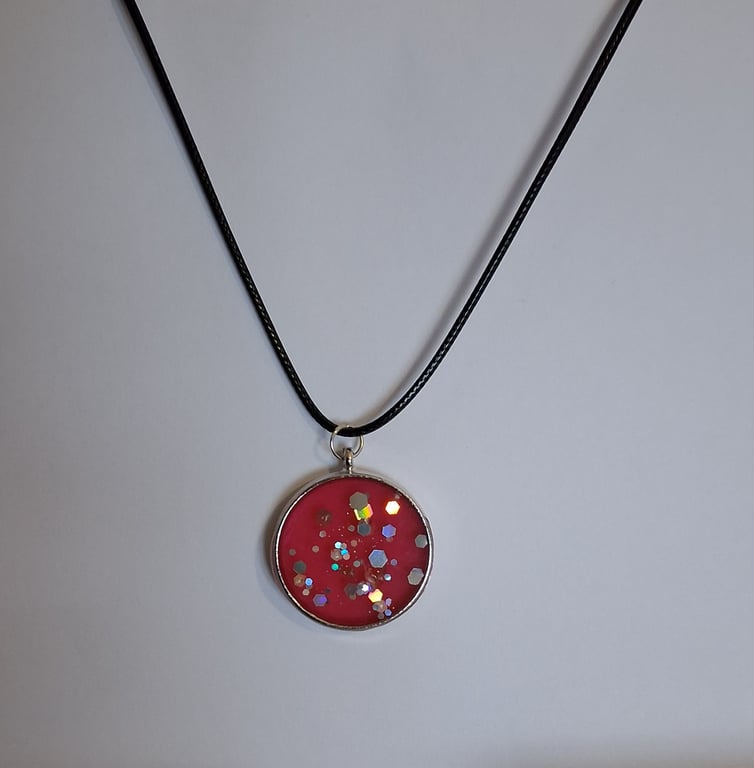 Handmade red glitter pendant on black waxed cord