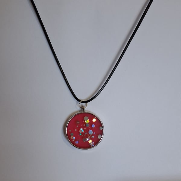 Handmade red glitter pendant on black waxed cord