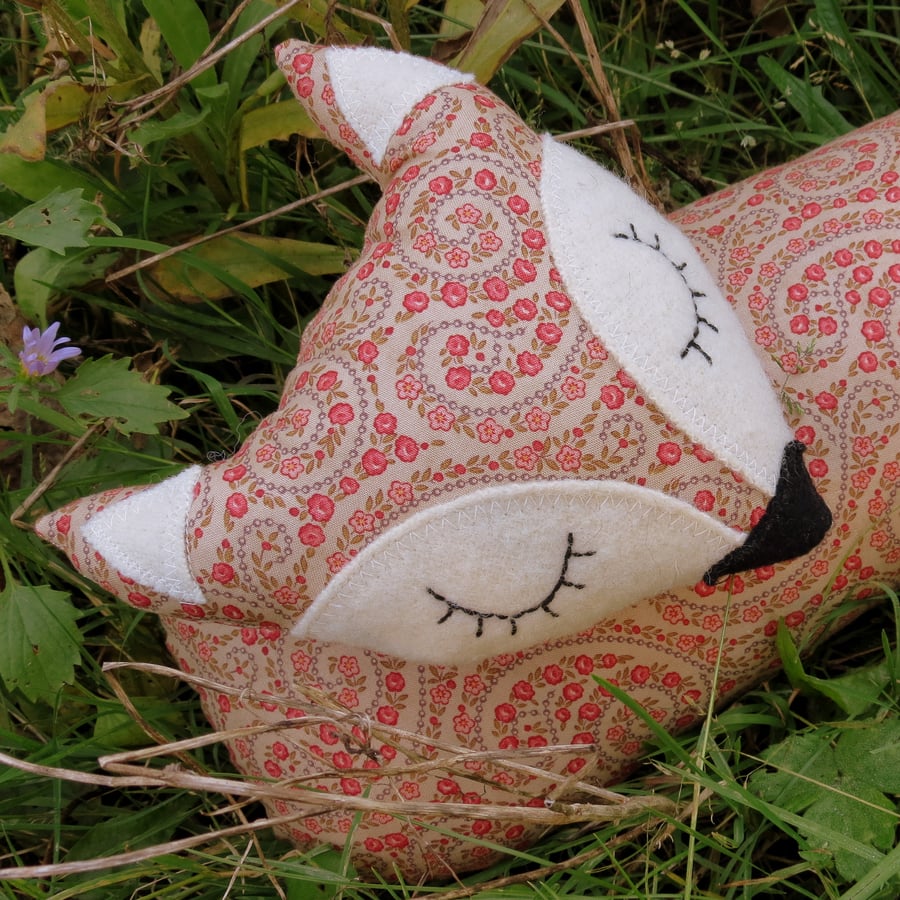 Long fox.  A draught excluder made from a paisley print cotton.