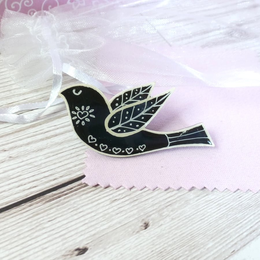 Black and white folk art bird brooch. Black bird hand-drawn jacket pin