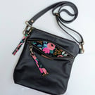 Black leather crossbody with pretty floral lining