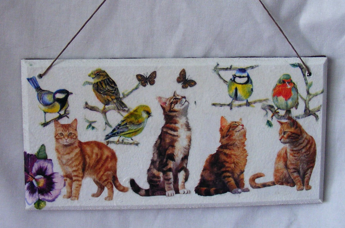 Cats and British birds decoupaged wall decoration.
