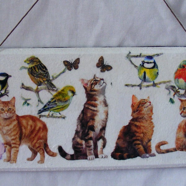 Cats and British birds decoupaged wall decoration.