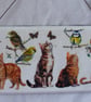 Cats and British birds decoupaged wall decoration.