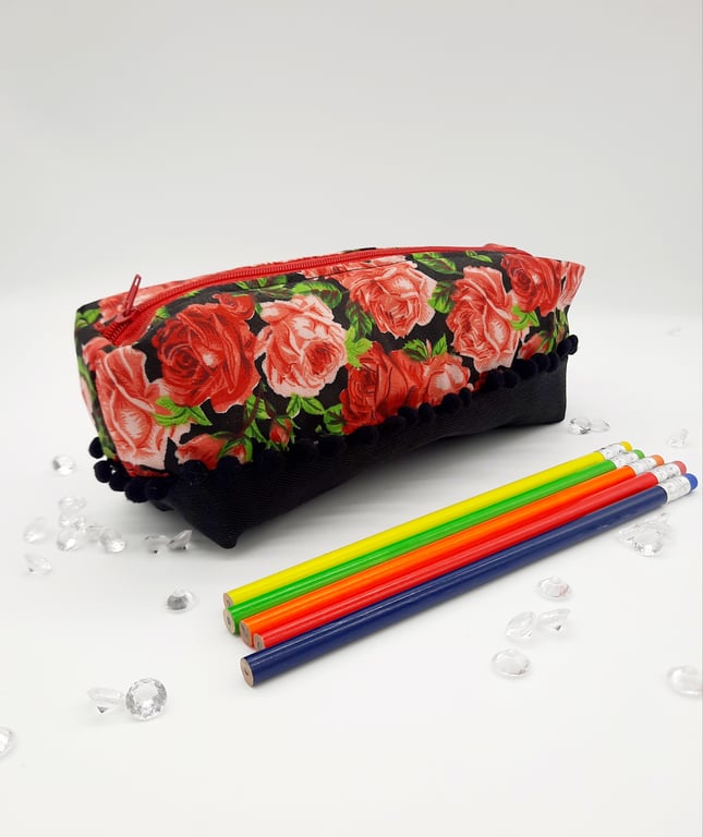 Red roses and black denim, pencil case with a bobble trim. 