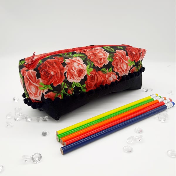 Red roses and black denim, pencil case with a bobble trim. 