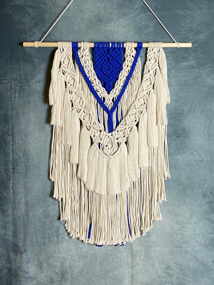 Macrame wall hanging with intricate knot design, royal blue and beige colours