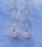 Drop earrings with wirework spirals and rose quartz stones