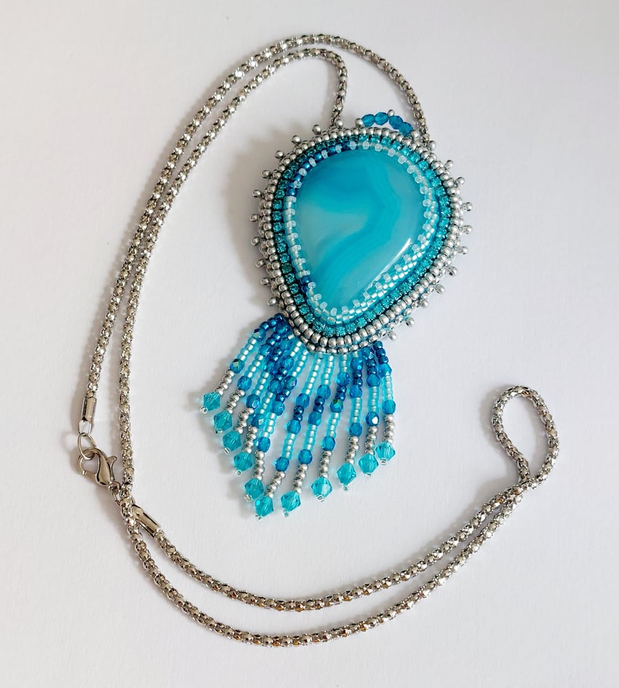 Bead Embroidered  fringed Blue Agate pendant on a silver tone chain 
