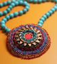 Celtic disk pendant on turquoise bead necklace