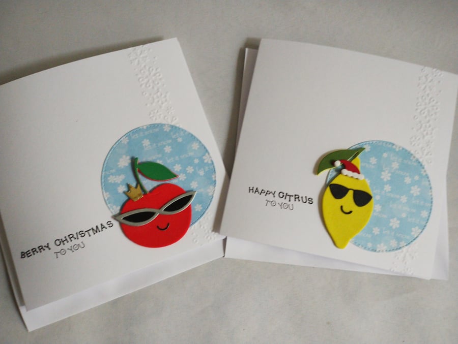 A pair of Punny Fruity Christmas Cards - Happy Citrus - Berry Christmas 