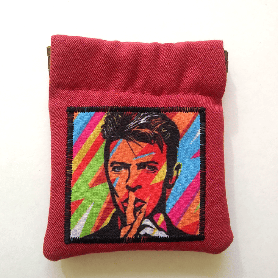 Small red coin purse or earbud pouch featuring musical legend