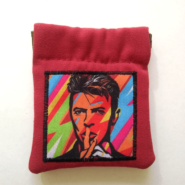 Small red coin purse or earbud pouch featuring musical legend
