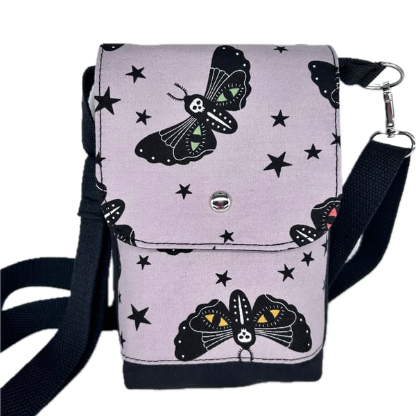 Death head moth print on this cross body bag with adjustable strap.