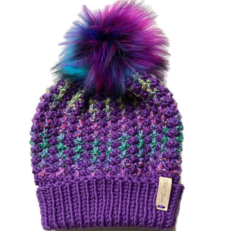 Hand knitted Adult beanie hat in purple with faux fur pompom