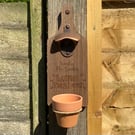 Wall mounted bottle opener with flowerpot cap catcher (weedin)