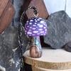 Small purple mushroom with fairy door. Pyrography hanging toadstool decoration.