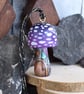 Small purple mushroom with fairy door. Pyrography hanging toadstool decoration.