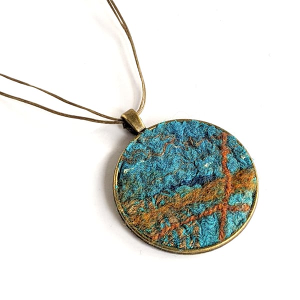 Felted pendant - tuquoises and orange in a bronze bezel