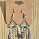 Boho style green, silver and bronze dangle earrings with feather charms