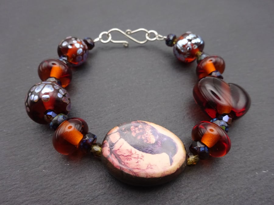 lampwork glass amber bracelet, ceramic raven jewellery