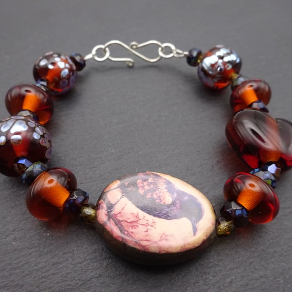 lampwork glass amber bracelet, ceramic raven jewellery