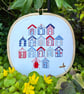 An embroidered gift, a seaside escape, beach huts framed  artwork 